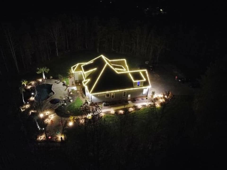 Aerial night photo of a lit roofline on a property lit by Mike&rsquo;s Cincinnati Christmas Lights