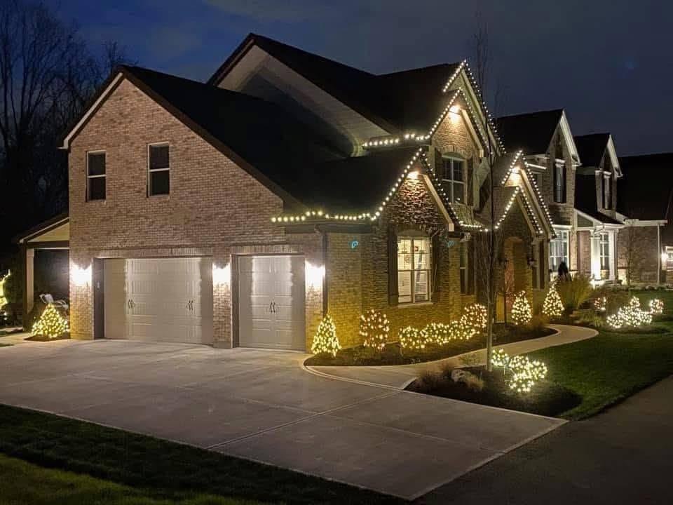 Brick two-story, roofline and bushes &mdash; Christmas light installation by Mike&rsquo;s Cincinnati Christmas Lights